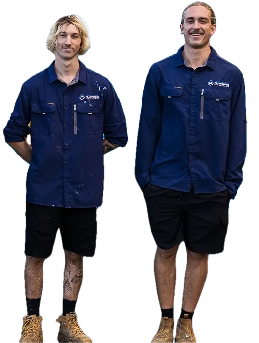 Two of our licensed plumbers smiling in front of the van