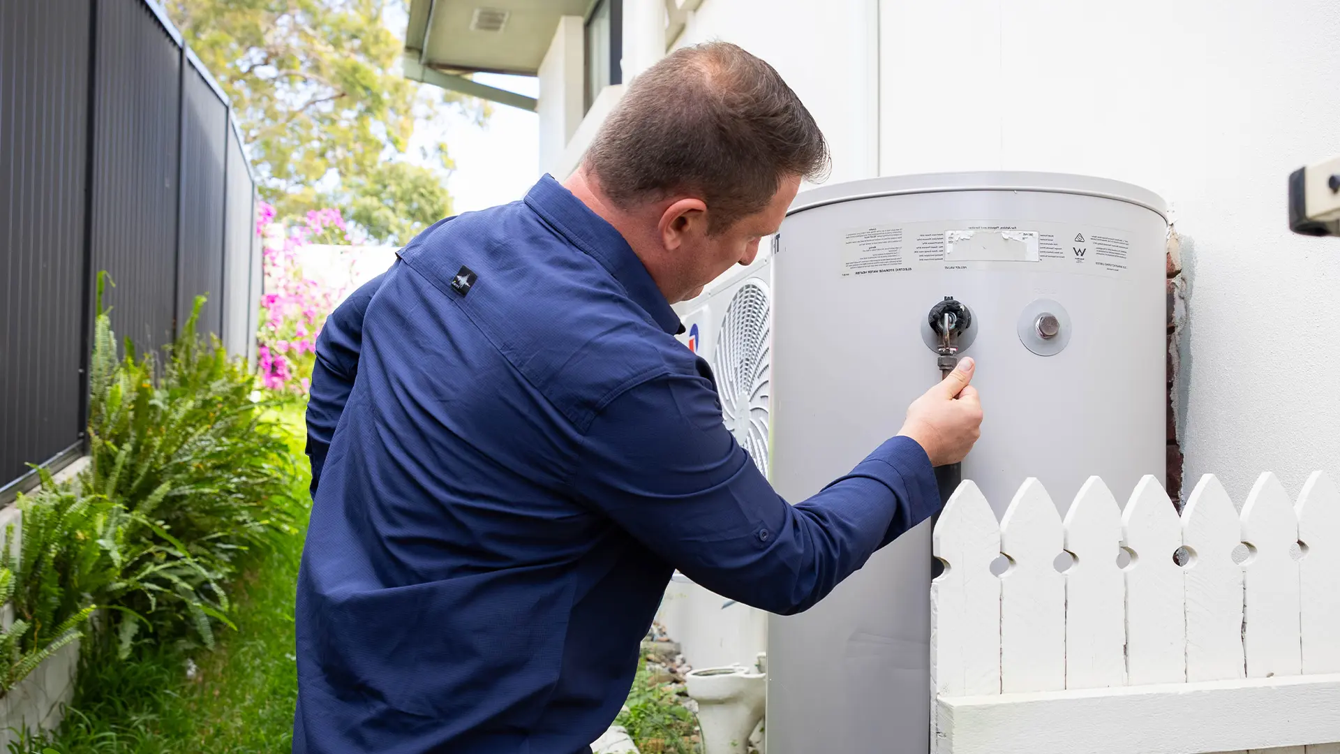 Plumber installing a new hot water system