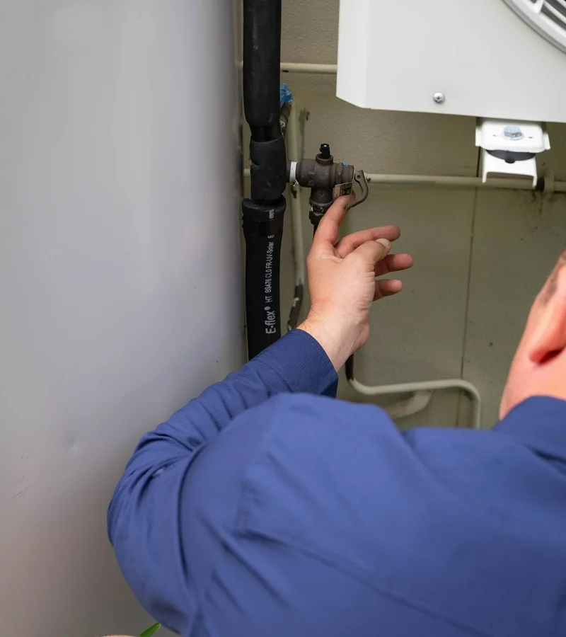 Licensed gas fitter connecting a gas hot water system